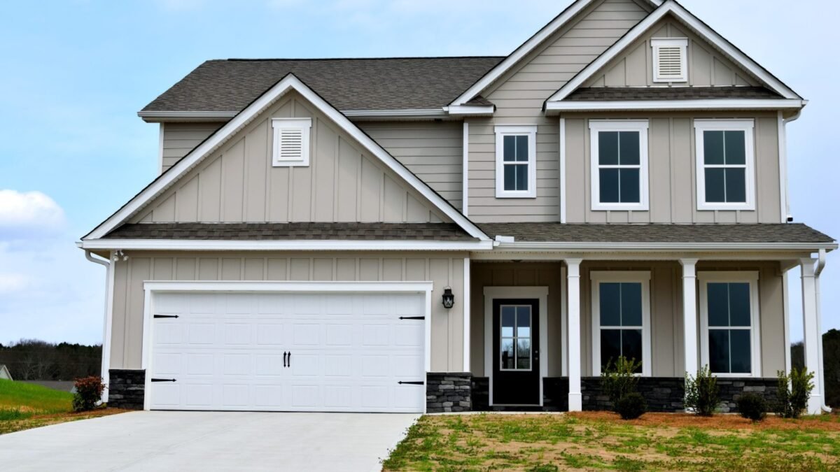 Two-story house with front-facing gable roofs and a white garage door, an example of a gable roof