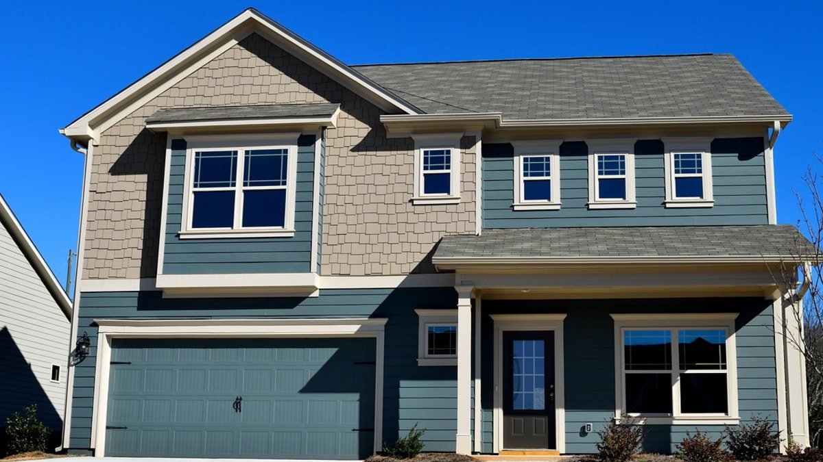 Two-story house with a blue two-car garage door